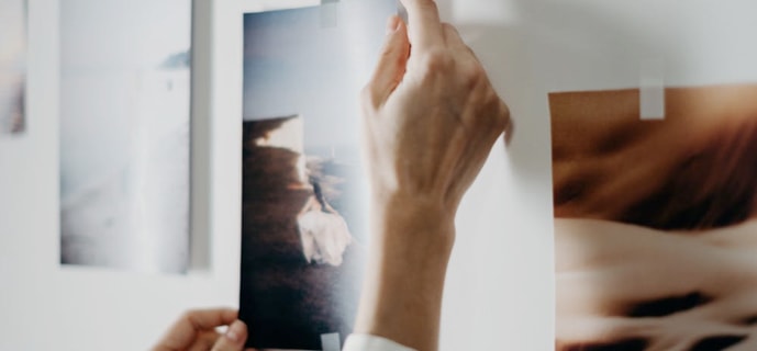 hands holding up a photograh for viewing